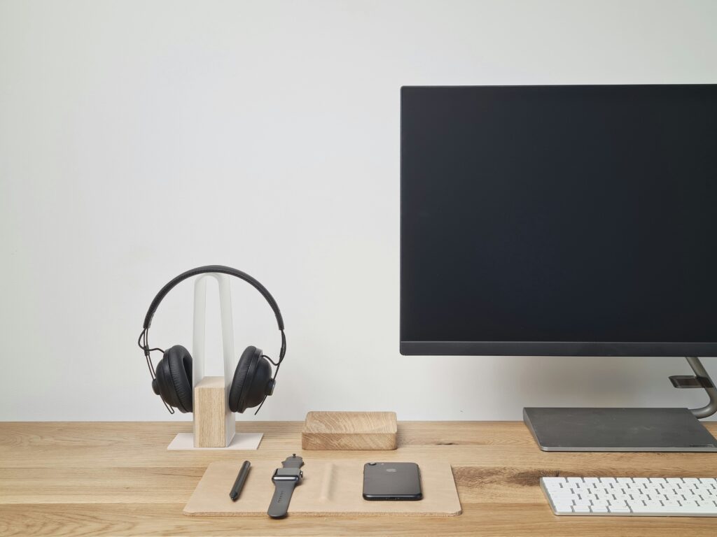 Lifestyle context image used in Best Budget Headset for Remote Work post — headset on desk stand, near intro section, positioned near Quick Take box.